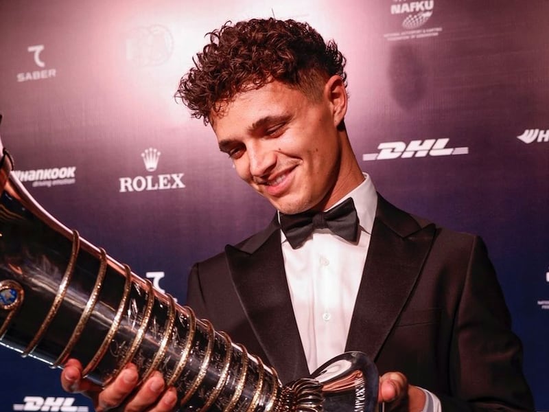Lando Norris recibe su trofeo de campeón de la F1, con Verstappen ausente por enfermedad